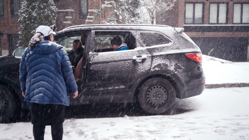 Snowy car with people